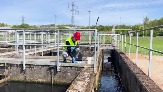 Tomas taking a wastewater sample at a treatment plant