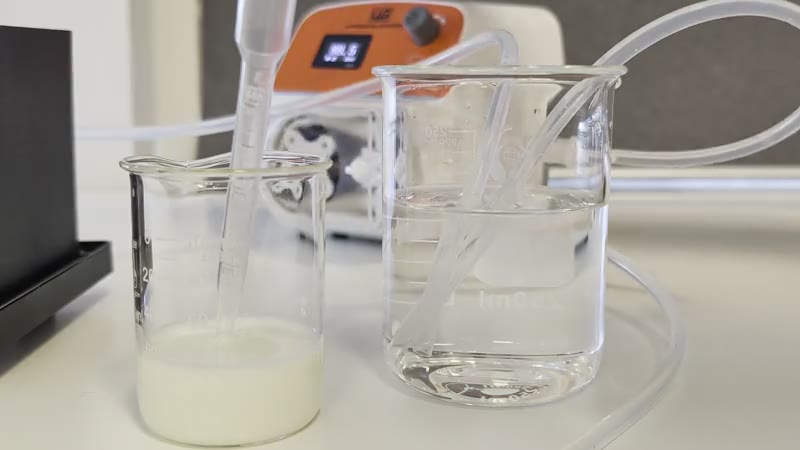 A peristaltic pump circulating liquid through tubing between a turbid product sample and a clear rinse liquid