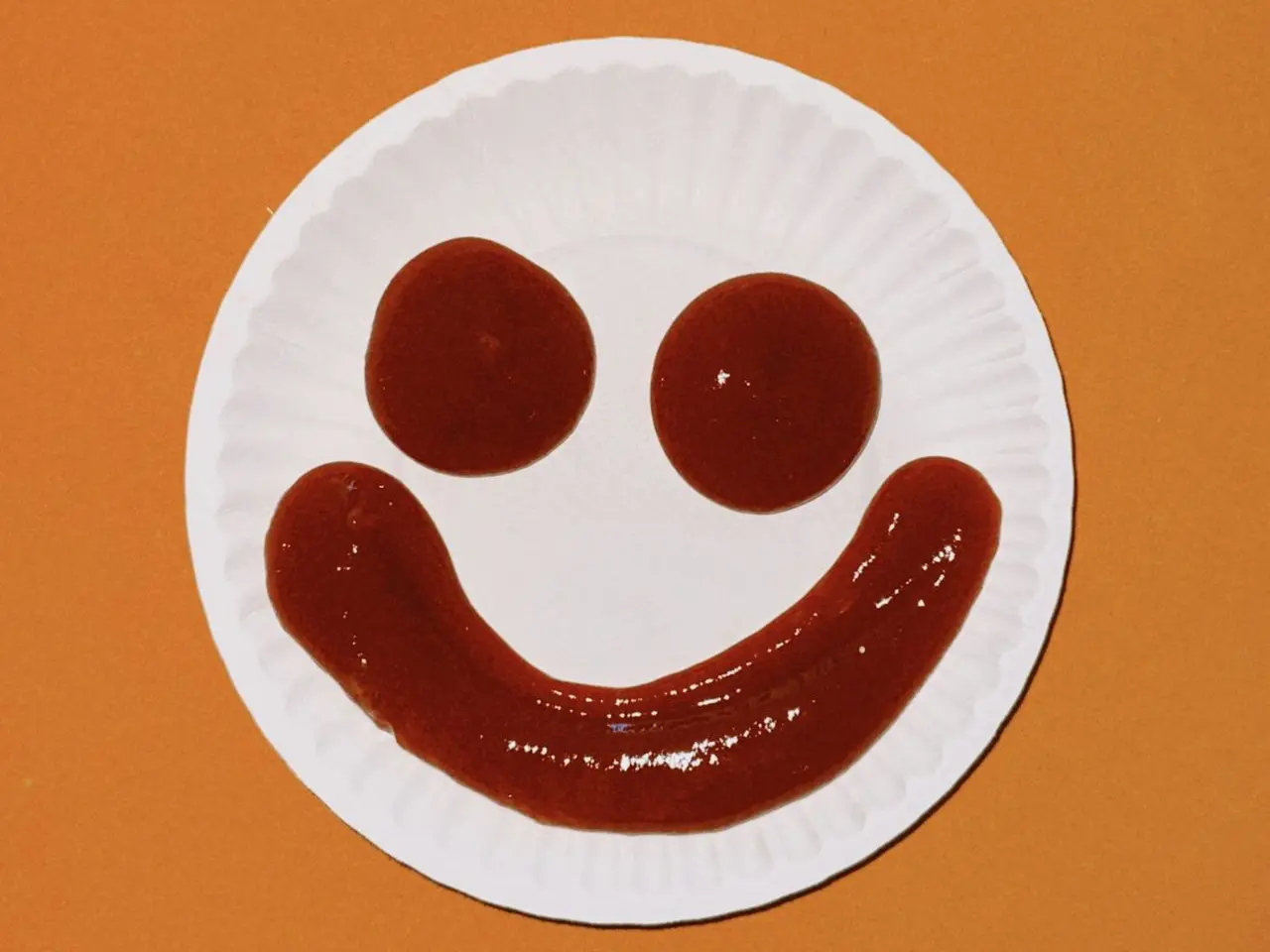 a paper plate with a smiley face drawn on it