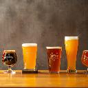 three clear drinking glasses on brown wooden table